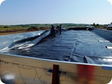 Once wall set-up is complete, unfold remaining liner over wall and secure with ridge cap.
