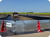 One end wall is left open until Bobcat work inside containment is complete.
